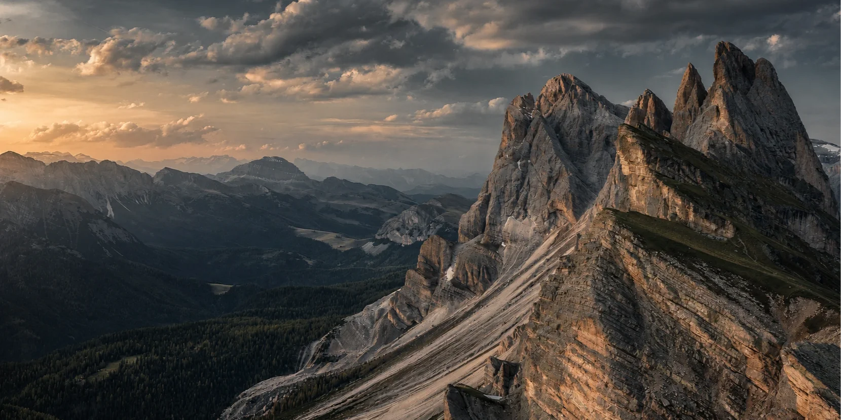 Mountain peaks beneath a cinematic sunset sky